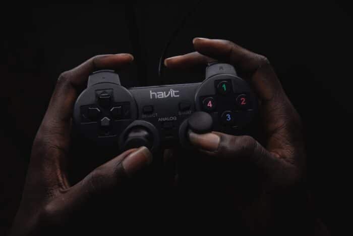 person holding black Havit game controller