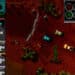 Screenshot from the classic top-down racing game 'Death Rally', showing a race in progress with various cars competing on a dirt track, relevant to the article about cheat codes for the game on various platforms like MS-DOS, IOS, Android, and Windows.
