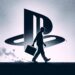 A figure carrying a briefcase walks away from a large PlayStation logo, casting a long shadow, symbolizing Sony's significant layoffs