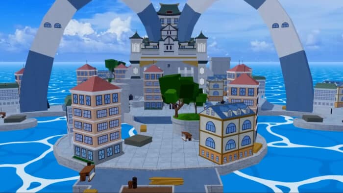 View of a central island town in Blox Fruits with colorful buildings, ocean surrounds, and a large arched structure rising in the background.