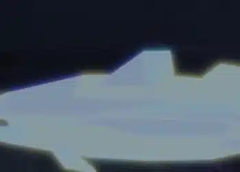 A glowing, neon-blue fish with sharp polygonal features floats in a dark underwater environment in the Roblox game Fisch, representing a mutated or rare fish varian