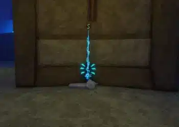 A glowing blue fishing rod is displayed upright on a pedestal inside a dimly lit stone chamber in Roblox. The rod emits a mystical aura, with a green dollar sign hovering above it, indicating its value or purchase option. The environment suggests a hidden or special location, possibly for acquiring rare fishing gear.