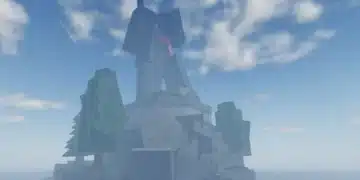 Massive stone statue with red scarf atop rocky island in Roblox "Fisch," marking the Statue of Sovereignty location under a bright, cloudy sky.