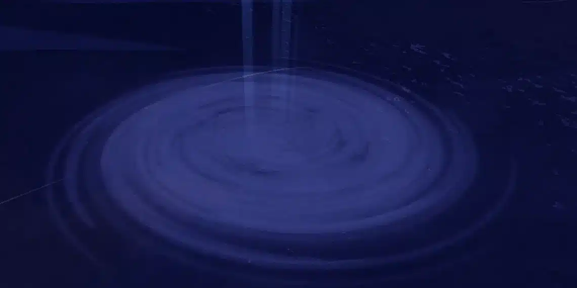 A swirling purple whirlpool or vortex in the middle of a dark ocean, viewed from above, with faint light beams descending into its center—likely representing the entrance to the Vertigo location in the Roblox game Fisch.